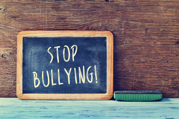 text stop bullying in a chalkboard