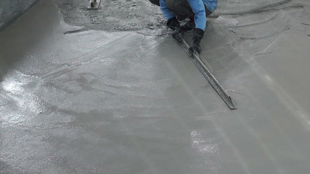Video of Special plastering equipment for troweling cement floor surface smoothening adjustment. Construction technique and skill