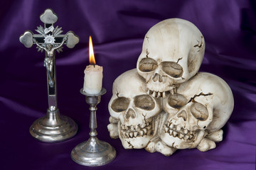 Crucifix and weathered human skull - Halloween background