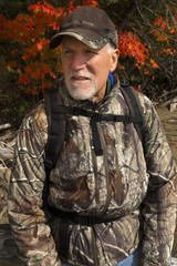 Senior Maine Guide in camo jacket at Flagstaff Lake, Maine.