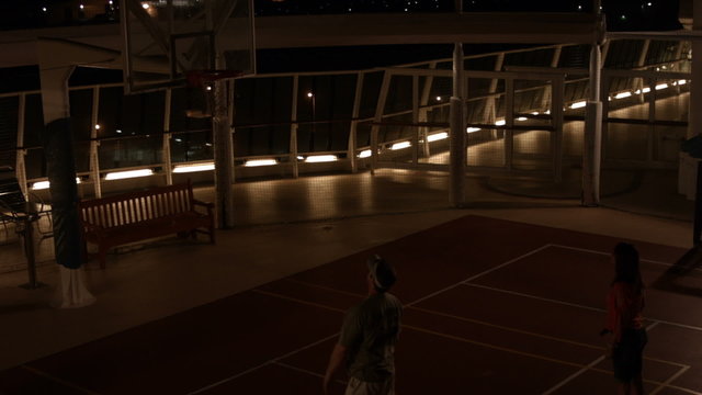 Couple playing basketball on cruise night time dark BM HD 1840