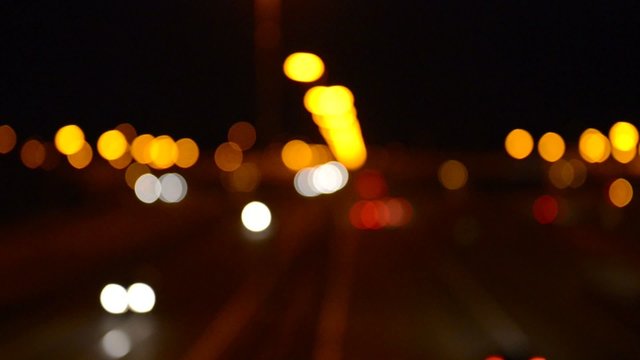 Defocused traffic on a highway at night.
