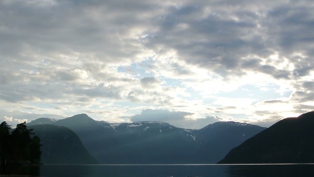 Time lapse of clouds moving over the Sognefjord in Norway during a sunset.