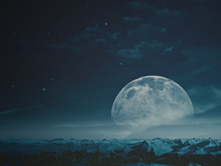 Fototapeta premium Foggy night with beauty Moon over snowy mountains. NASA imagery used
