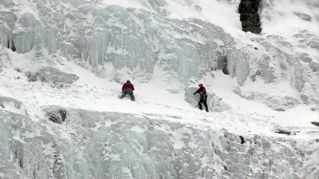 Ice climbers on snow ledge HD