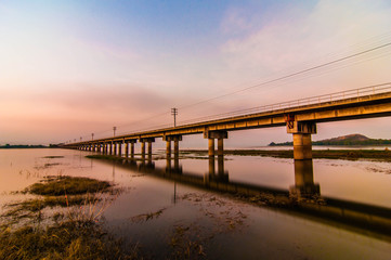 Fototapeta na wymiar railroad bridge on sunset background.