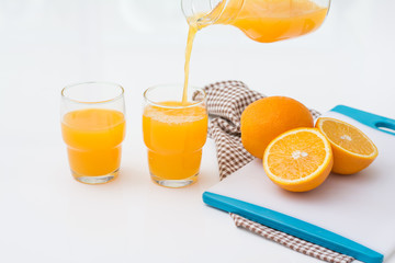Pouring orange juice into the glass