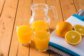 Fresh juice with fruits orange on wooden table