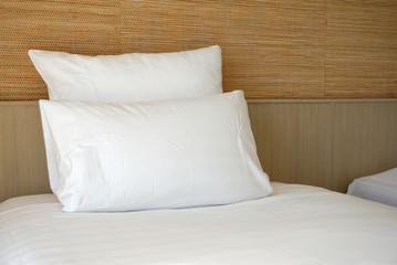 Fototapeta na wymiar Double white pillow on white bed sheet