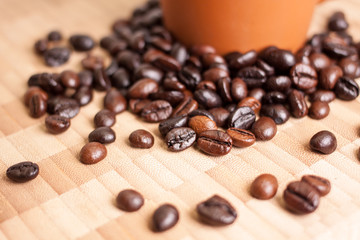 Cup and Coffee beans on wooden background