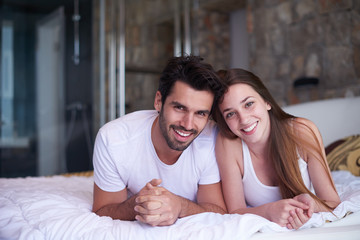 couple relax and have fun in bed