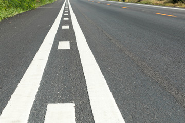 Asphalt road with white double solid line