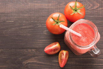 Healthy vegetable. Glass of red tomato juice on wooden table