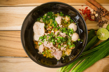 bowl of noodles with vegetables on wooden table. delicious noodl