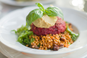 Beetroot, tofu, carrot and chickpea patty served with warm lenti