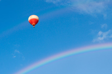 Hot-air balloons in the cloudy blue sky