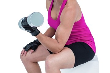 Fototapeta premium Muscular woman exercising with dumbbells 
