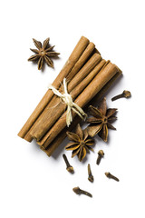 cinnamon sticks, anise and cloves on white background