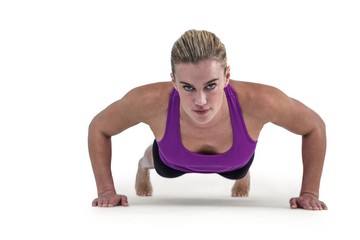Fototapeta na wymiar Muscular woman doing push ups 
