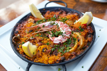 Tasty spanish paella with seafood on a white dish served in restaurant
