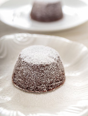dark chocolate lava cake on elegant white ceramic dish