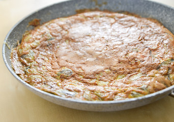 Italian frittata with various winter vegetables in a stone frying pan
