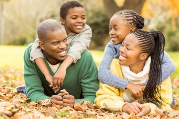 Portrait of a young family lying in leaves