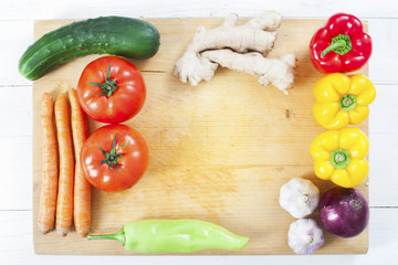 Healthy food background. Yellow and red pepper on chopping board.