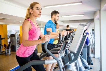 Fit people working out using machines