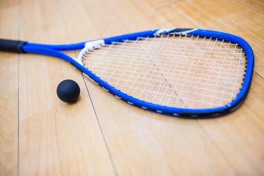 Close up of a squash racket and ball