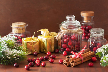 fresh cranberry in glass jars, winter decoration and gifts