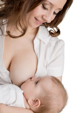 Studio photo of young mother breastfeeding