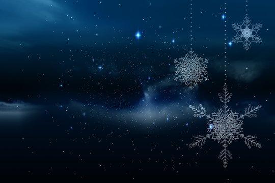 Snowflakes hanging against starry sky