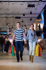 young couple with shipping bags