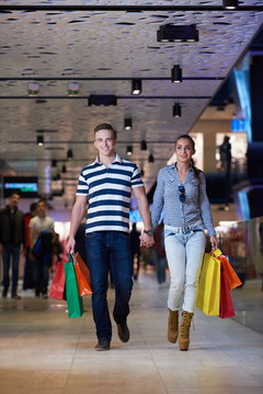 young couple with shipping bags