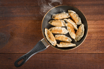 Asian food fried dumpling in cooking pan