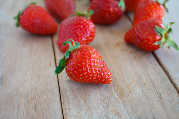 Fresh red strawberries on wooden table