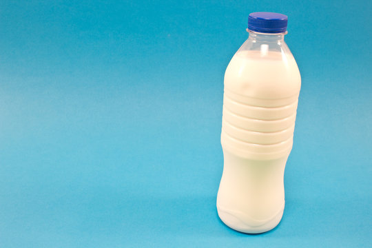 Bottle of milk isolated on blue background
