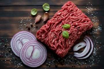 Fresh ground beef meat with seasonings, close-up, above view