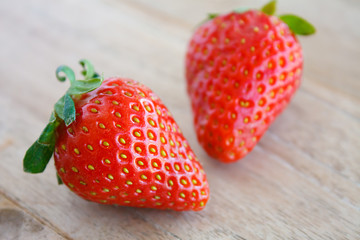 Ripe red strawberries on wooden table