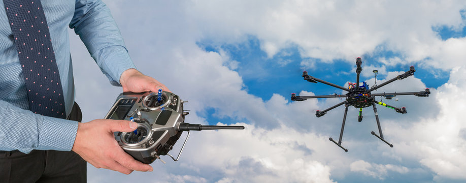 Drone flight remote controller in man's hands close up view and