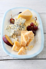 cheeses and grapes on plate