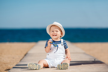 Portrait of a happy child with a hat on the beach