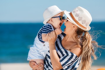 Young mother and her young son on the beach. - 93982189