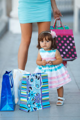 Woman during the shopping with the little girl