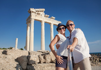 Smiling young couple take a selfie photo on antique ruins © Soloviova Liudmyla