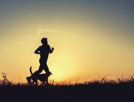 Sunset runner with dog silhouette