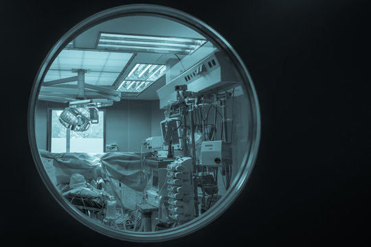 View Of Medical Equipment Through The Operating Room Door Round Window. /cyanotype//