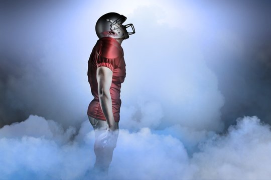 Composite image of american football player looking up