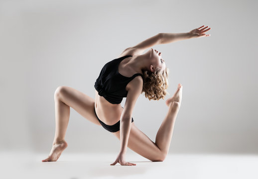 young beautiful woman in black T-shirt and shorts dancing